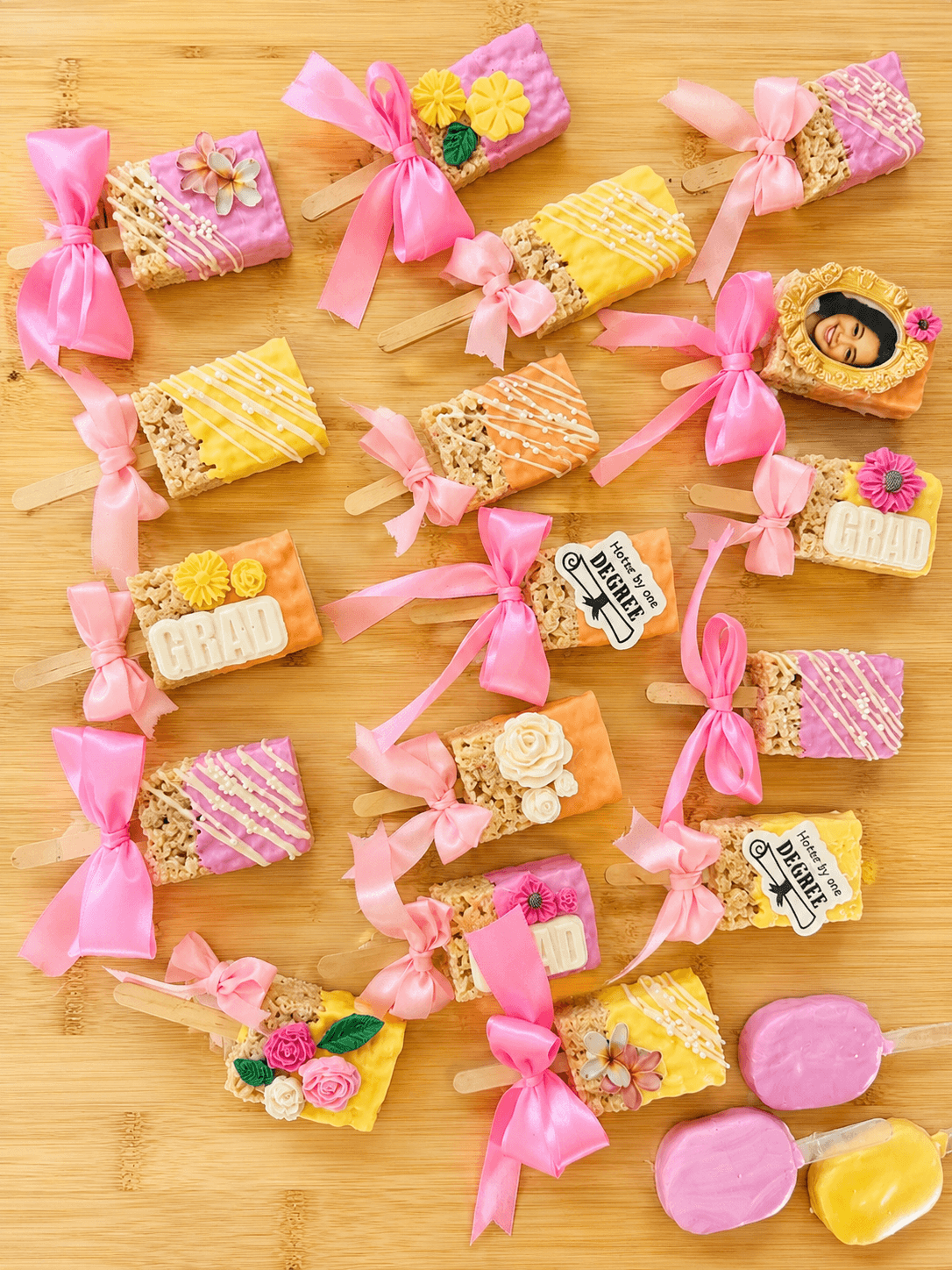 Graduation rice krispy treat pops with edible images and ribbons